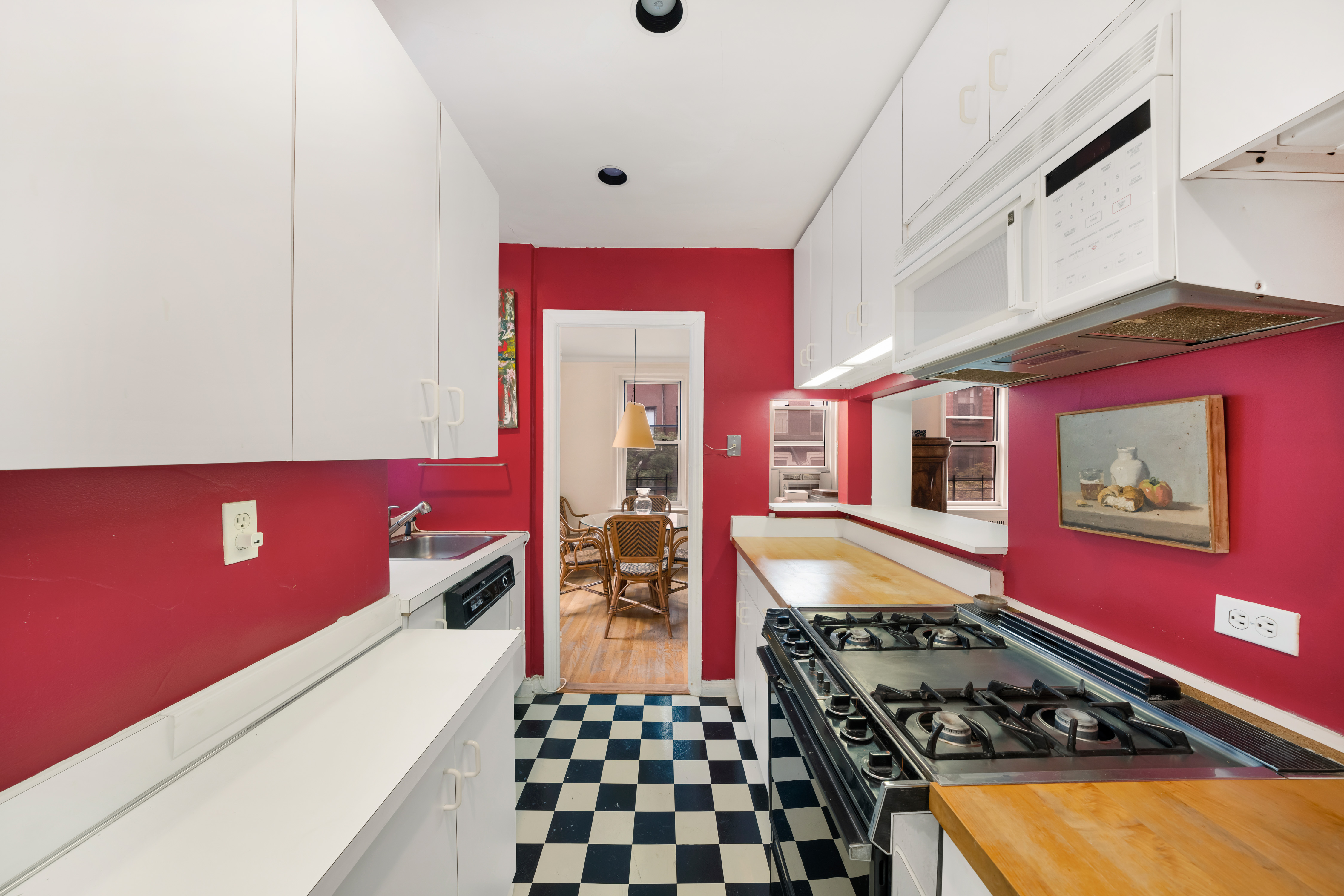 310 West 55th Street, Unit 5G Manhattan, NY 10019 - Photo 4 of 7 a kitchen with stainless steel appliances granite countertop a stove a sink and a refrigerator