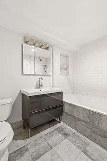 a bathroom with a sink a toilet and bathtub