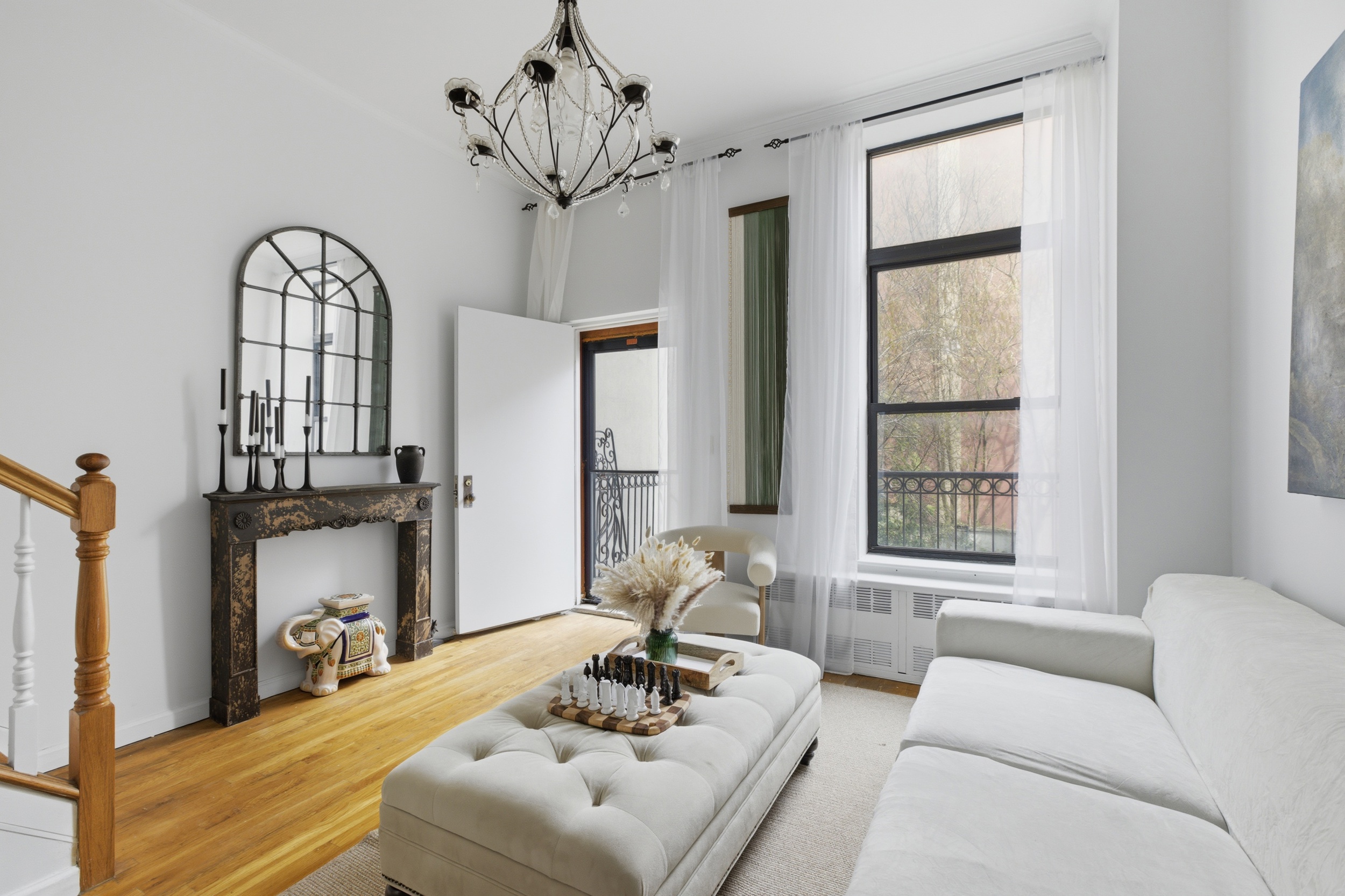 127 West 123rd Street Manhattan, NY 10027 - Photo 10 of 28 a living room with furniture chandelier and a window