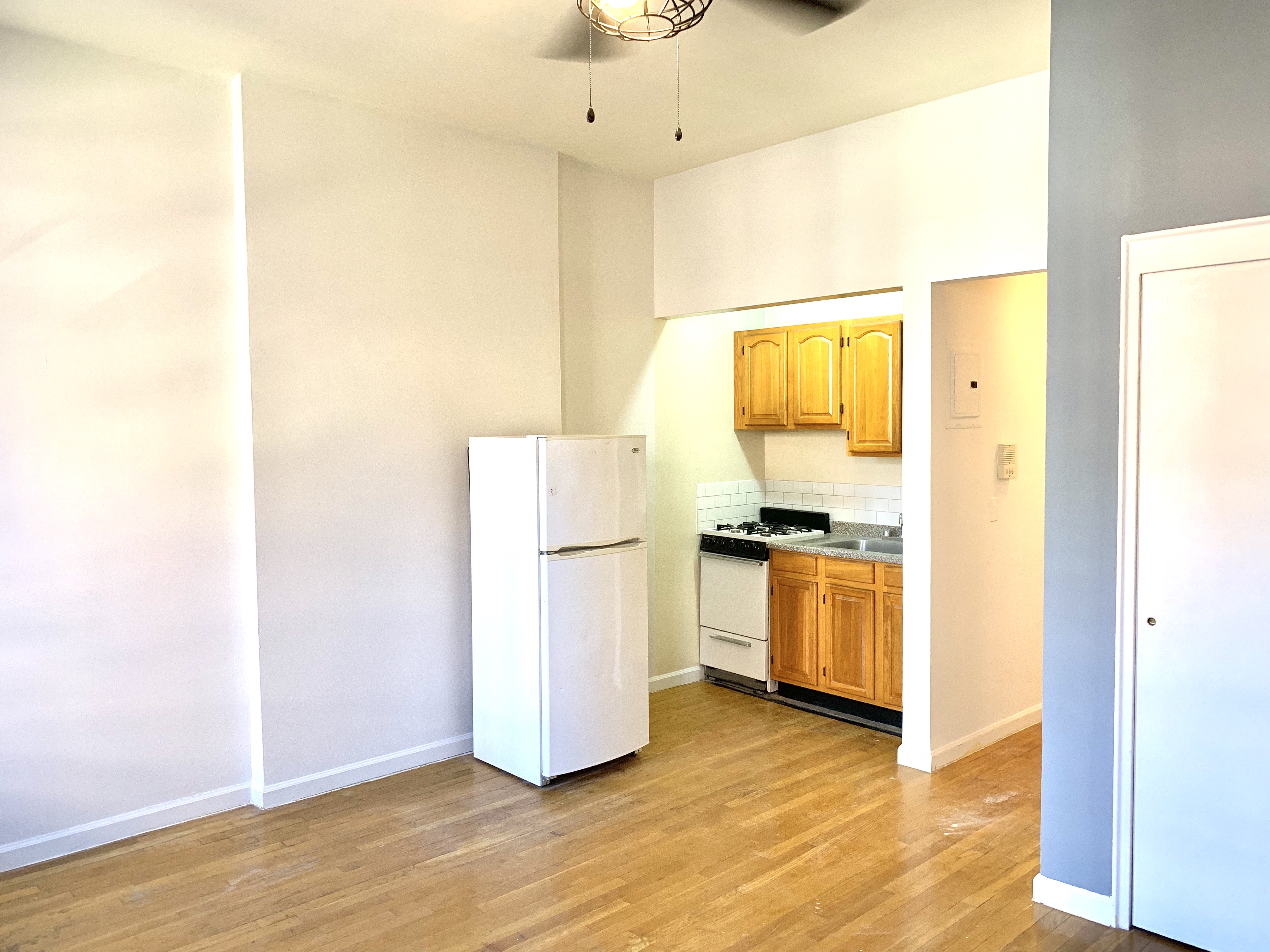 116 West 131st Street, Unit 7 Manhattan, NY 10027 - Photo 3 of 5 a view of a kitchen with a sink and a refrigerator
