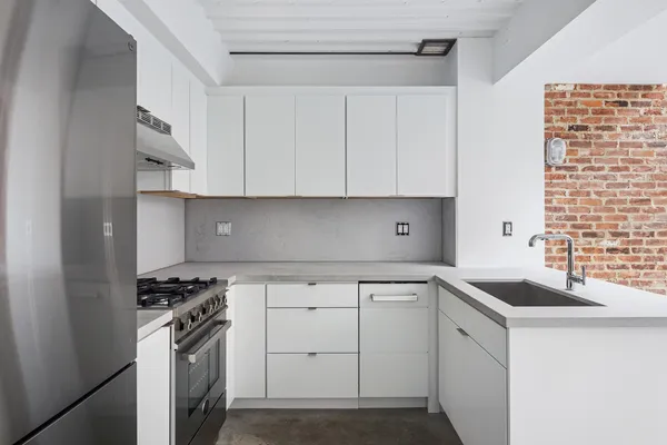 a kitchen with cabinets appliances and a sink