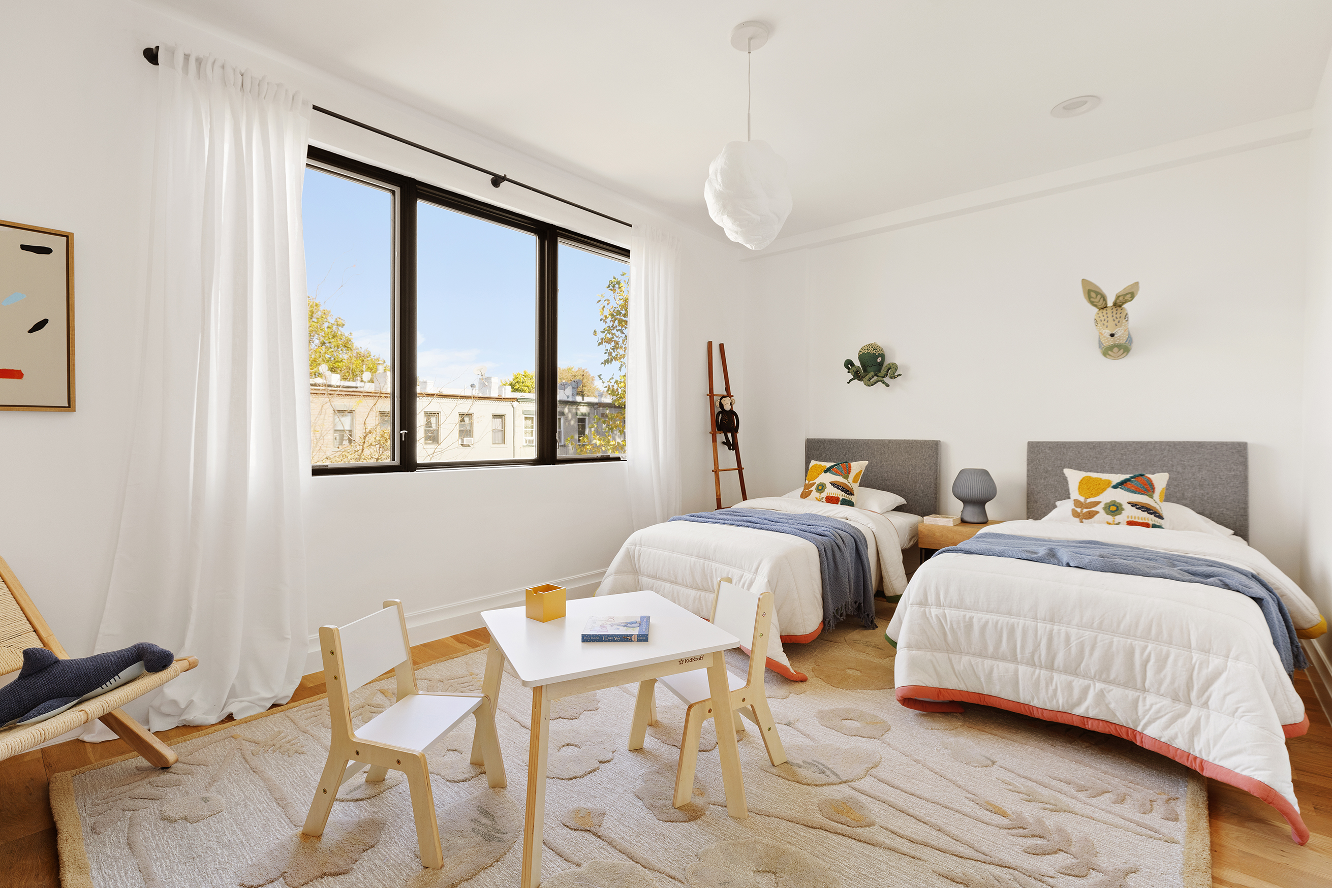 203 Halsey Street Brooklyn, NY 11216 - Photo 9 of 21 a bedroom with two beds and a window