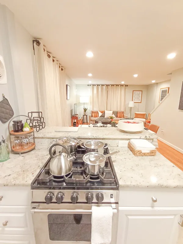 a kitchen with stainless steel appliances granite countertop a sink stove and cabinets