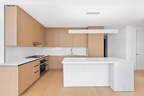 a kitchen with stainless steel appliances a sink stove and cabinets