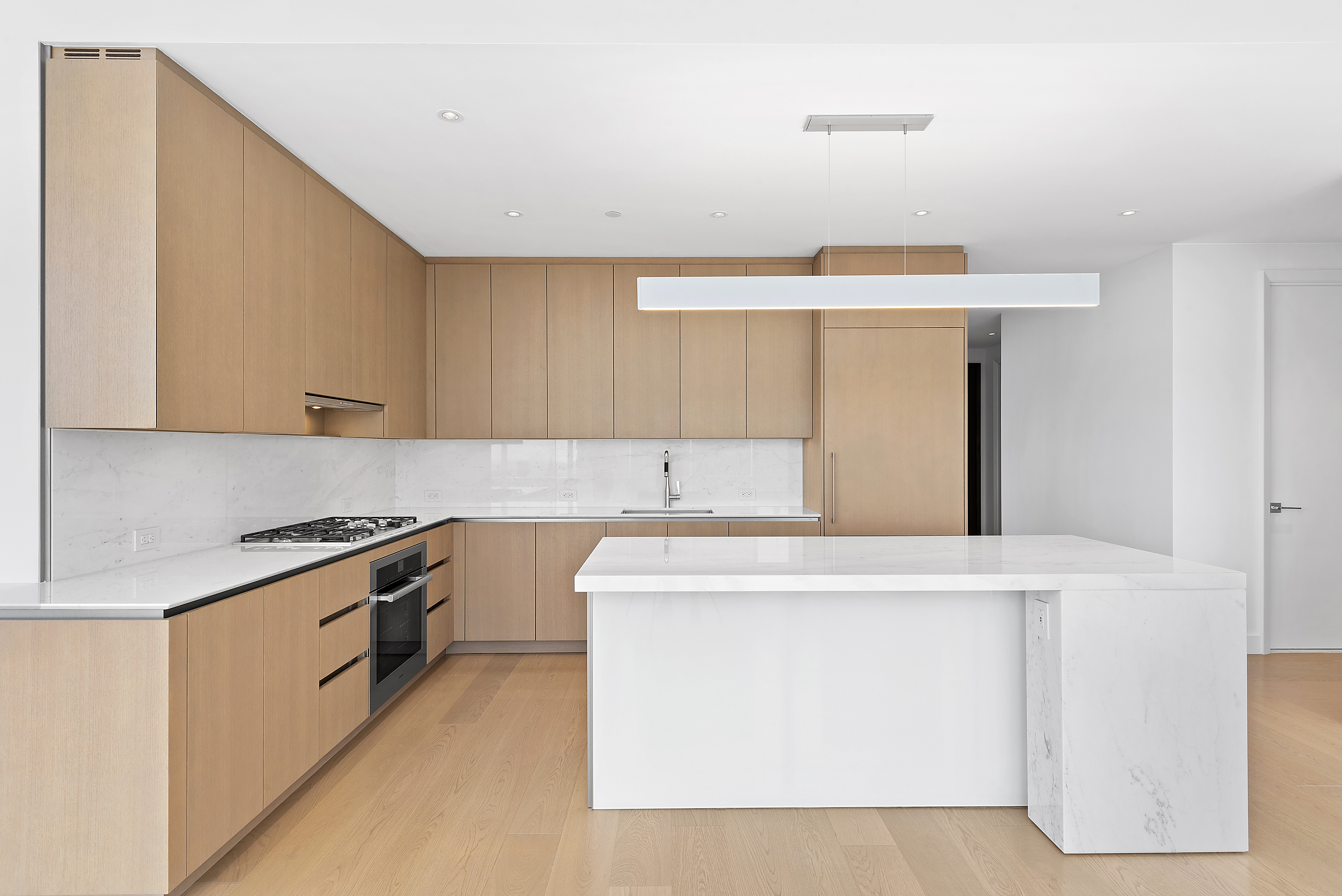 15 Hudson Yards, Unit 75A Manhattan, NY 10001 - Photo 2 of 31 a kitchen with stainless steel appliances a sink stove and cabinets