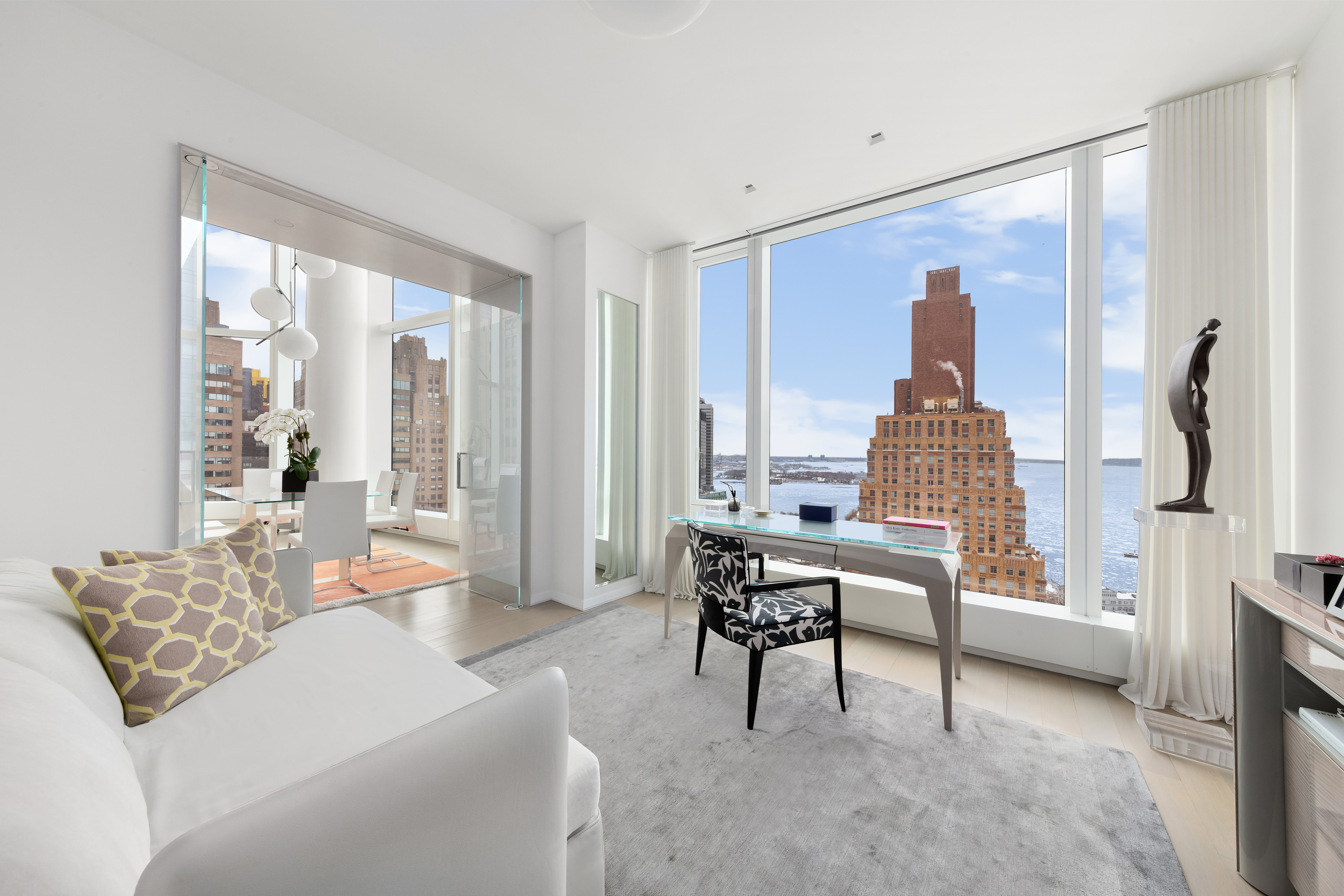 50 West Street, Unit 30B Manhattan, NY 10006 - Photo 9 of 25 a living room with furniture and a large window