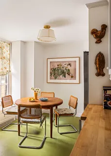 a front view of a house with garden and trees