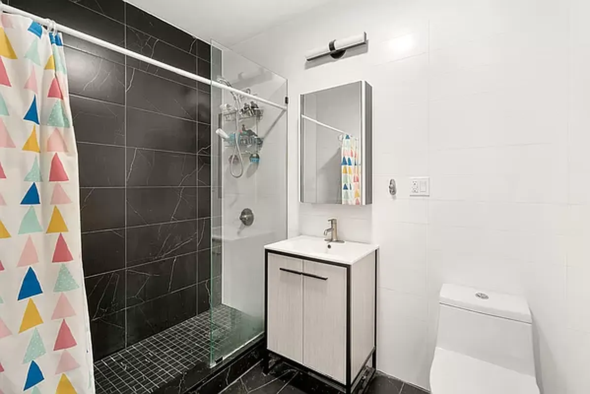 18 A Bleecker Street, Unit 1A Brooklyn, NY 11221 - Photo 6 of 6 a bathroom with a sink toilet and shower