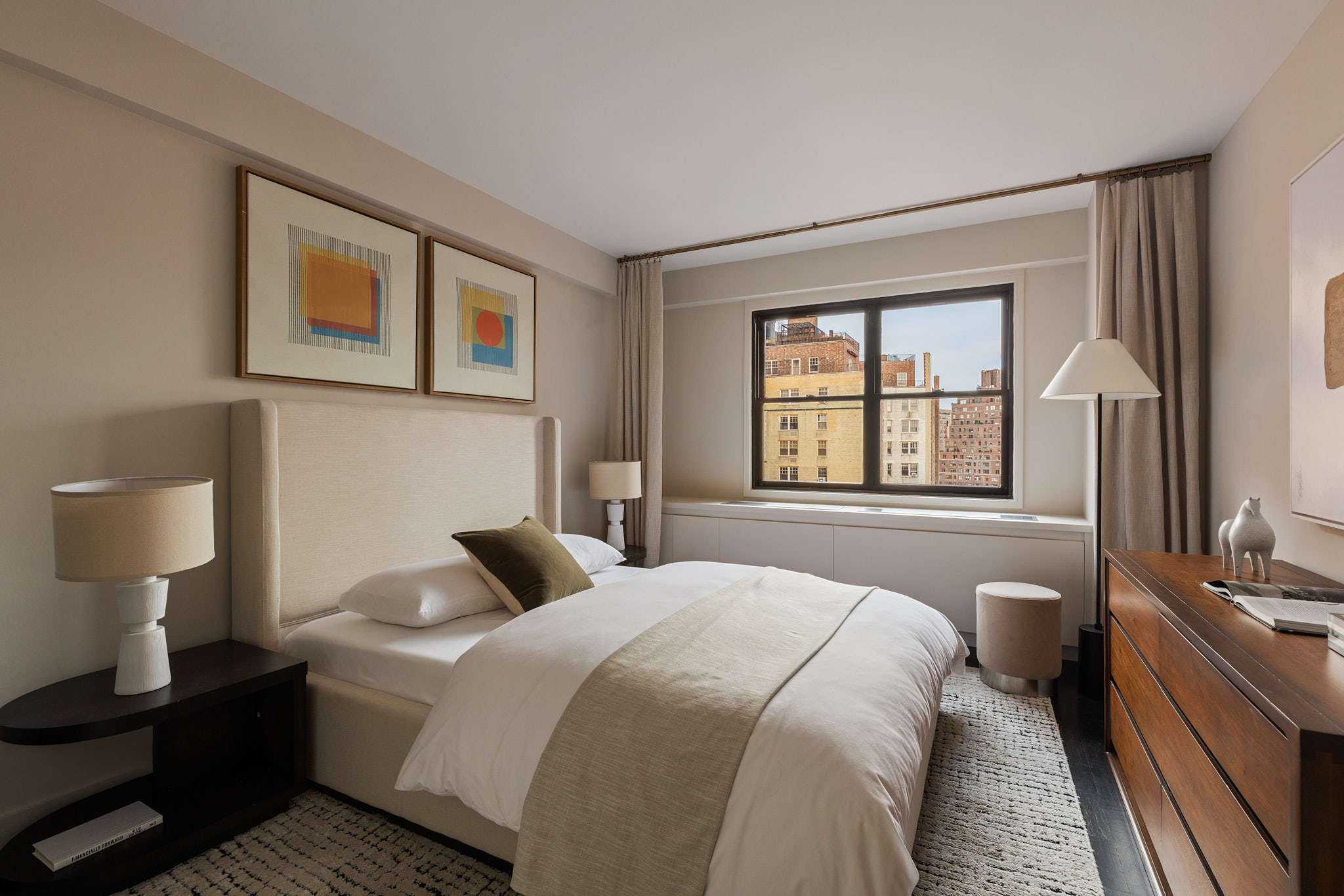 31 Jane Street, Unit 16G Manhattan, NY 10014 - Photo 13 of 20 a bedroom with a bed and wooden floor