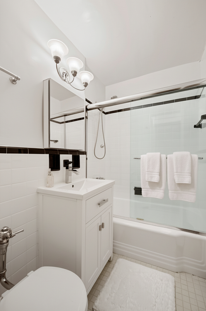 309 East 87th Street, Unit 5A Manhattan, NY 10128 - Photo 6 of 9 a bathroom with a sink a toilet and shower