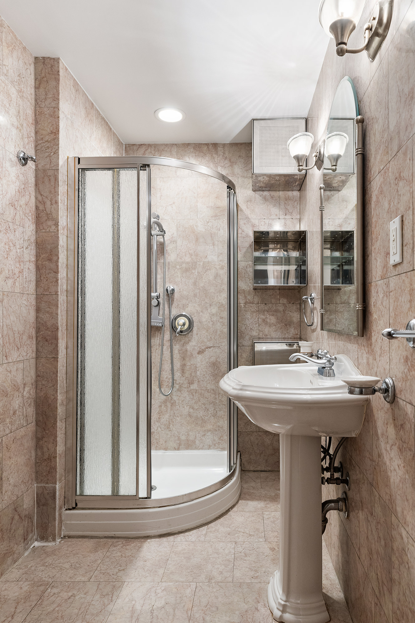 23 East 81st Street, Unit 1 Manhattan, NY 10028 - Photo 7 of 23 a bathroom with a sink a toilet and shower