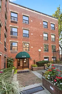 a view of a brick building with a yard