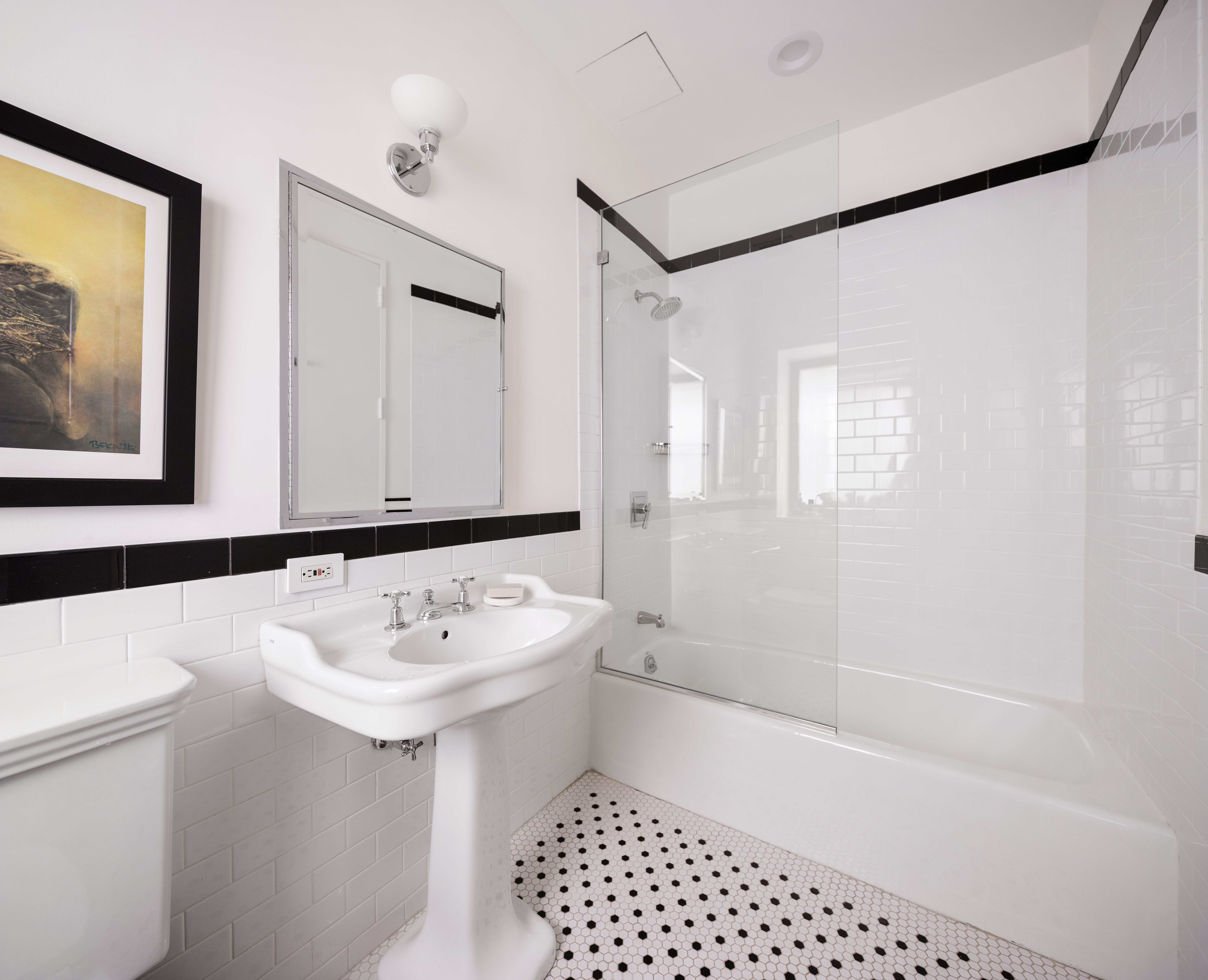 388 West Broadway, Unit 2 Manhattan, NY 10012 - Photo 22 of 27 a bathroom with a sink a mirror and a shower