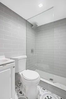 a bathroom with a toilet a sink and shower