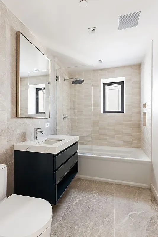 a bathroom with a sink a toilet and a bathtub