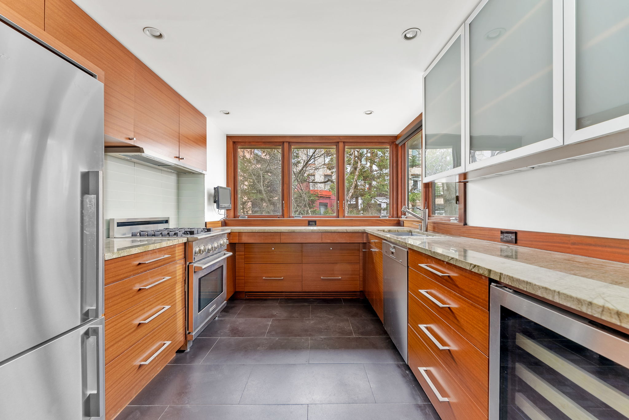 694 10th Street, Unit 2 Brooklyn, NY 11215 - Photo 6 of 22 a large kitchen with stainless steel appliances granite countertop a stove and a sink