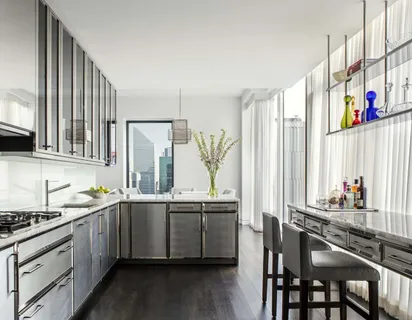 a kitchen with stainless steel appliances a sink and cabinets