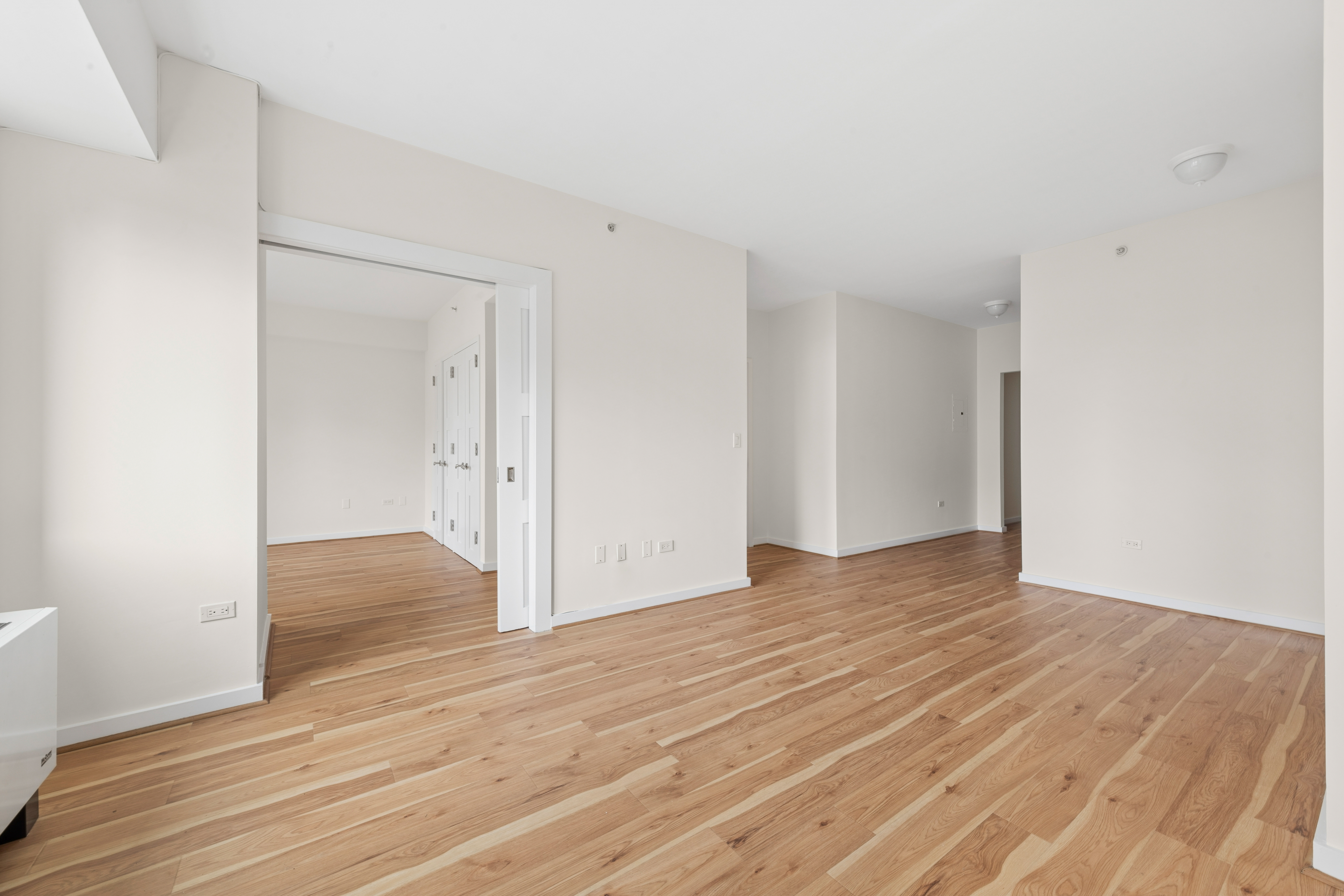 425 5th Avenue, Unit 23D Manhattan, NY 10016 - Photo 6 of 20 a view of an empty room and wooden floor