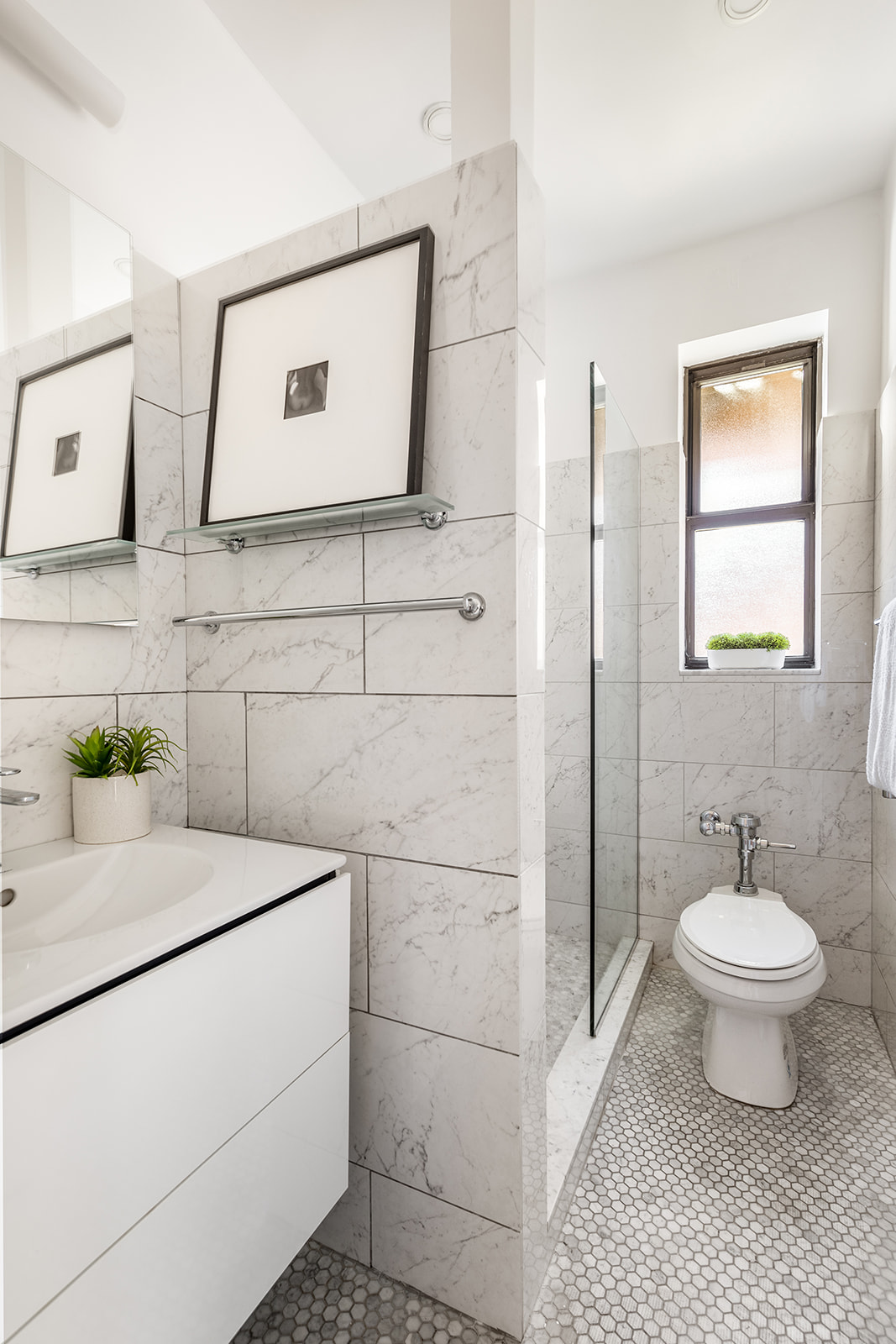 357 West 55th Street, Unit 4D Manhattan, NY 10019 - Photo 8 of 11 a bathroom with a sink toilet and shower