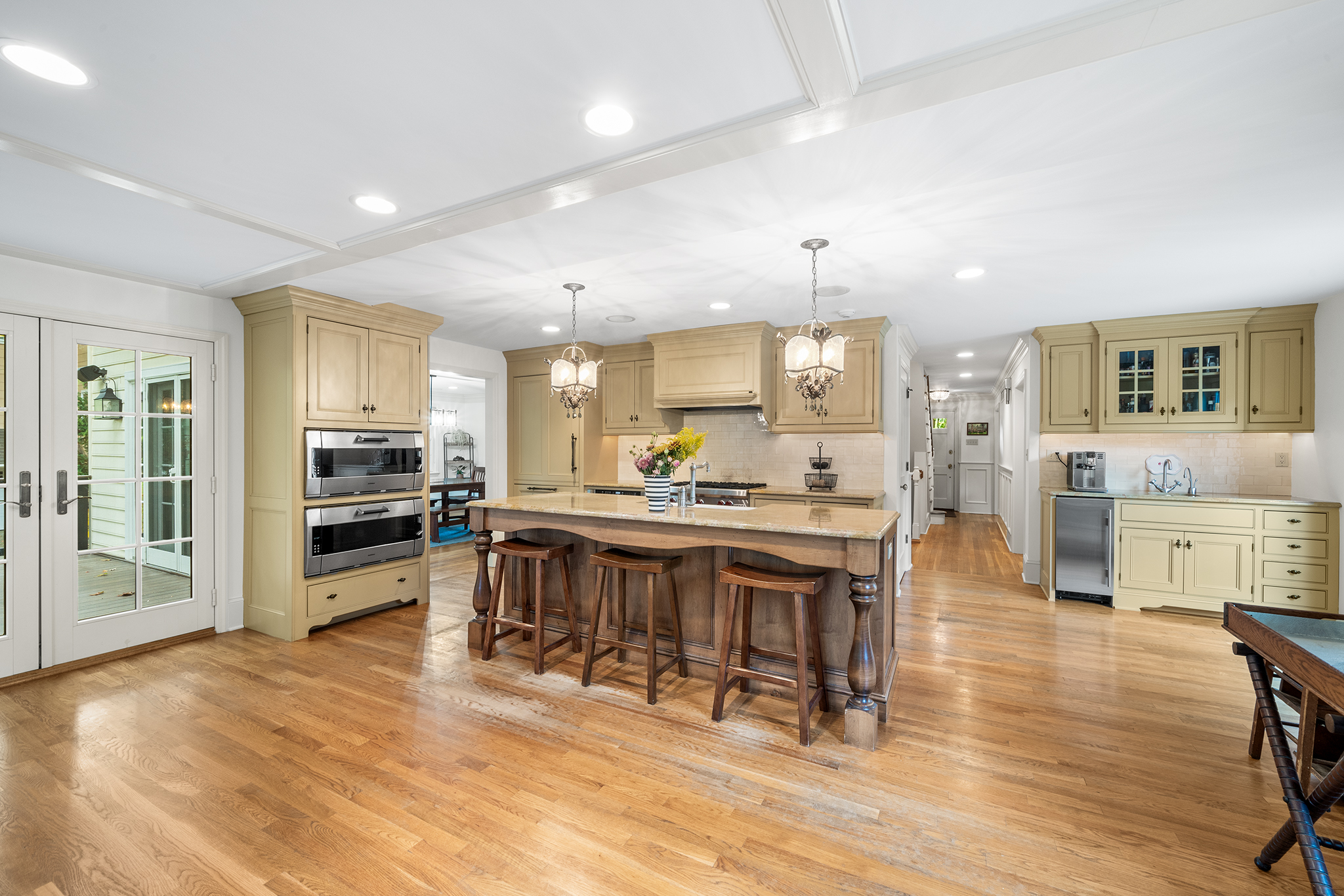 718 Arlington Road Narberth, PA 19072 - Photo 7 of 47 a kitchen with stainless steel appliances kitchen island granite countertop a refrigerator a stove a dining table and chairs with wooden floor