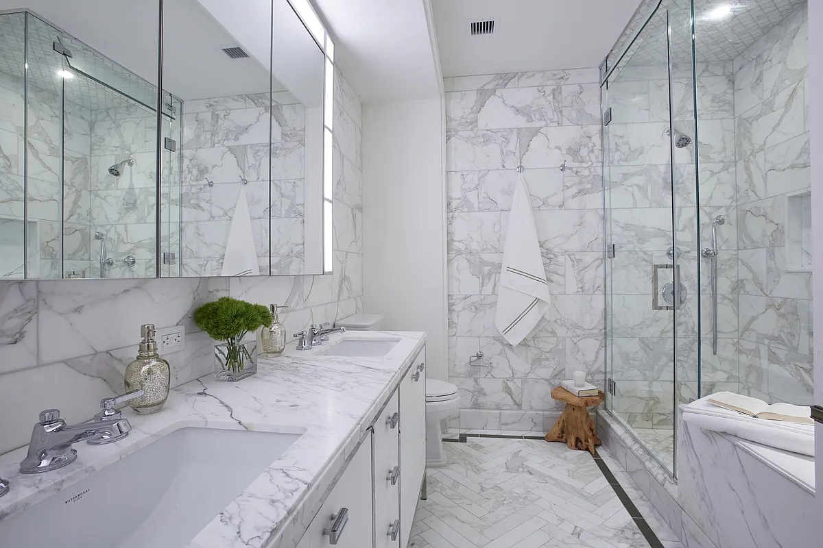 100 Barclay Street, Unit 13G Manhattan, NY 10007 - Photo 7 of 26 a bathroom with a granite countertop sink a toilet and bathtub