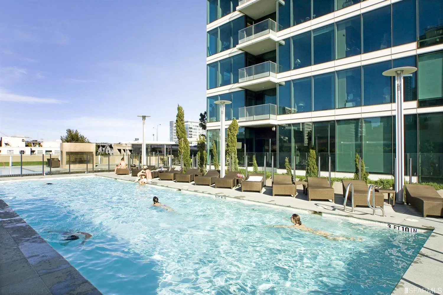 a view of a swimming pool with outdoor seating