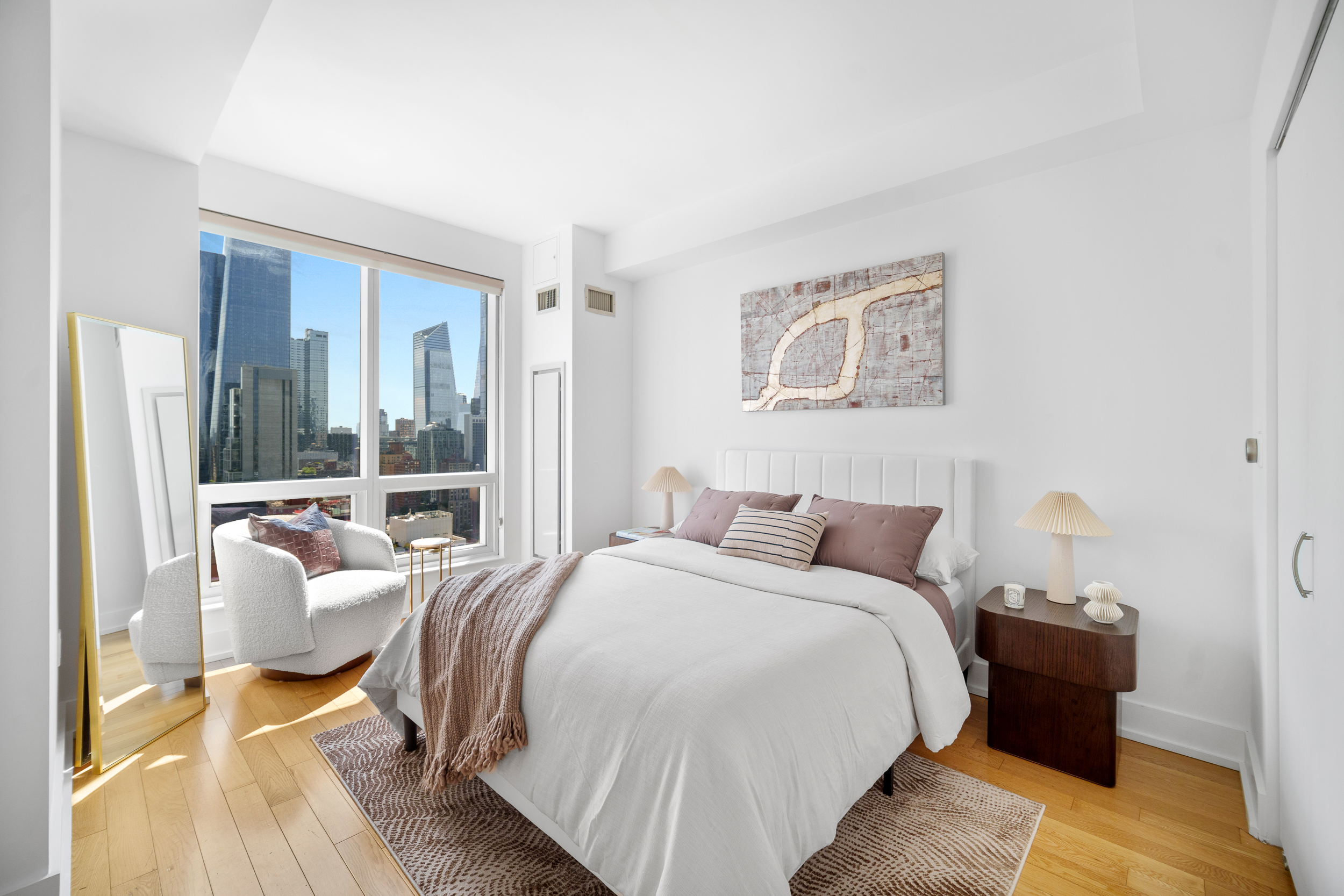 350 West 42nd Street, Unit 27K Manhattan, NY 10036 - Photo 7 of 18 a bedroom with a bed and a couch