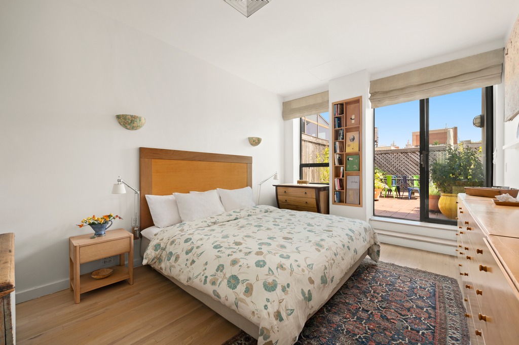 205 West 89th Street, Unit PH6/7 Manhattan, NY 10024 - Photo 6 of 20 a bedroom with a bed and wooden floor