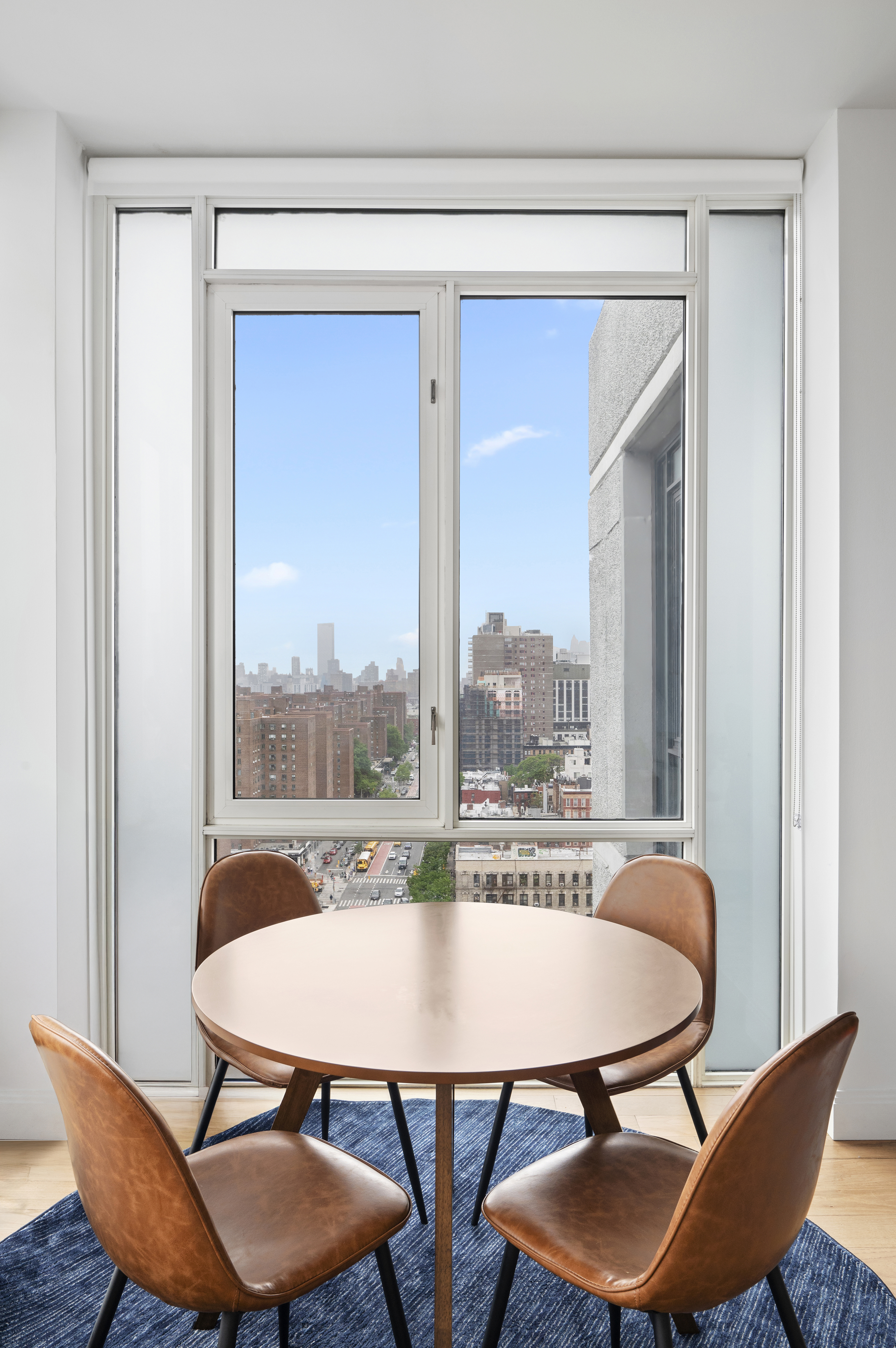 385 1st Avenue, Unit 18G Manhattan, NY 10010 - Photo 4 of 20 a view of a dining room with furniture and a window