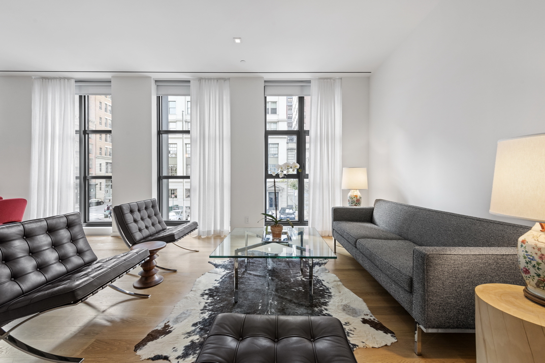 11 North Moore Street, Unit 2B Manhattan, NY 10013 - Photo 2 of 12 a living room with furniture and floor to ceiling windows