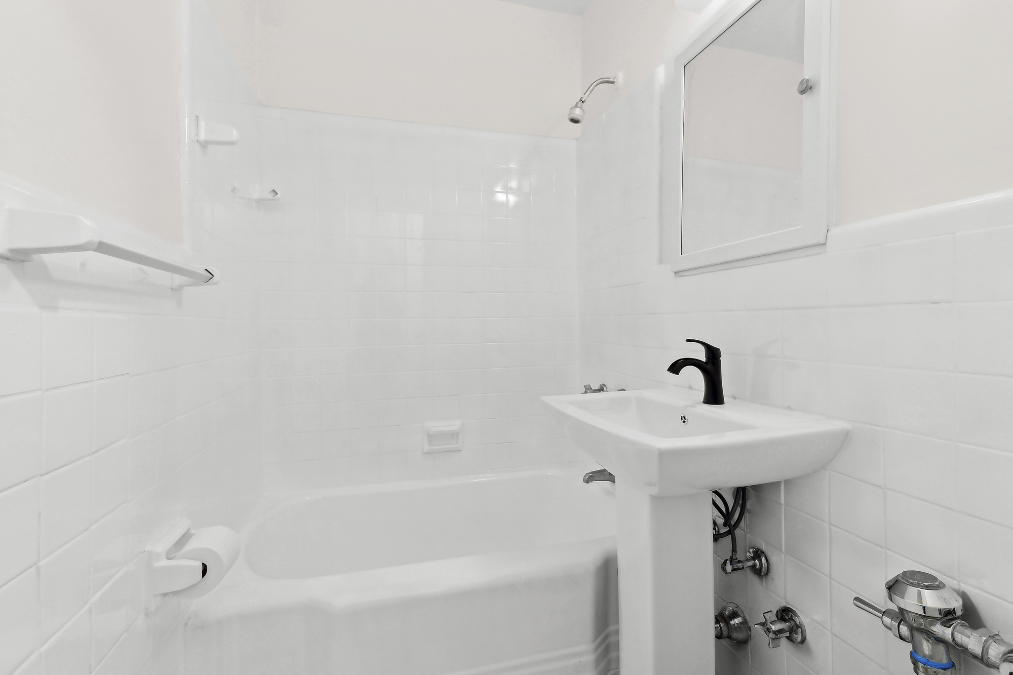 313 East 89th Street, Unit 4F Manhattan, NY 10128 - Photo 4 of 5 a bathroom with a sink and a shower