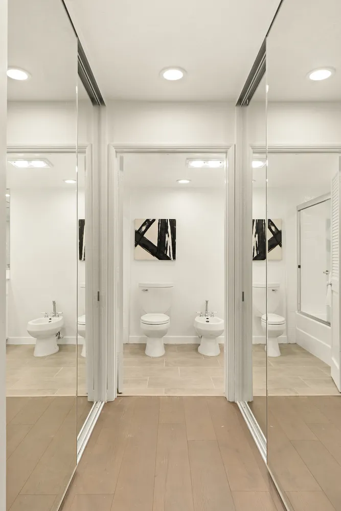 a bathroom with a toilet sink and shower