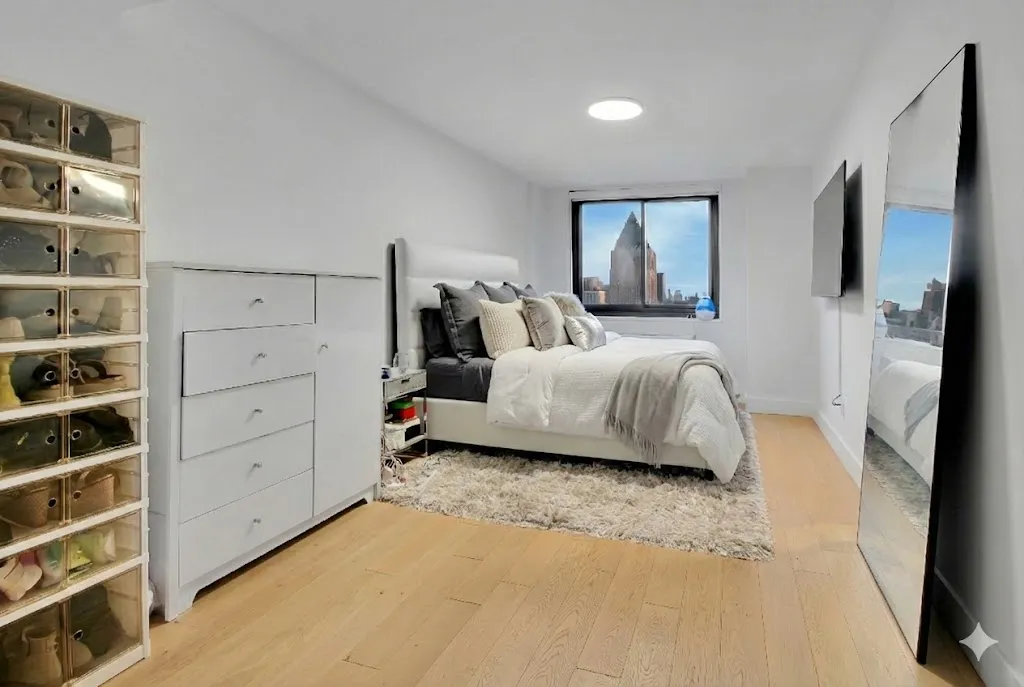 a spacious bedroom with a bed and a window