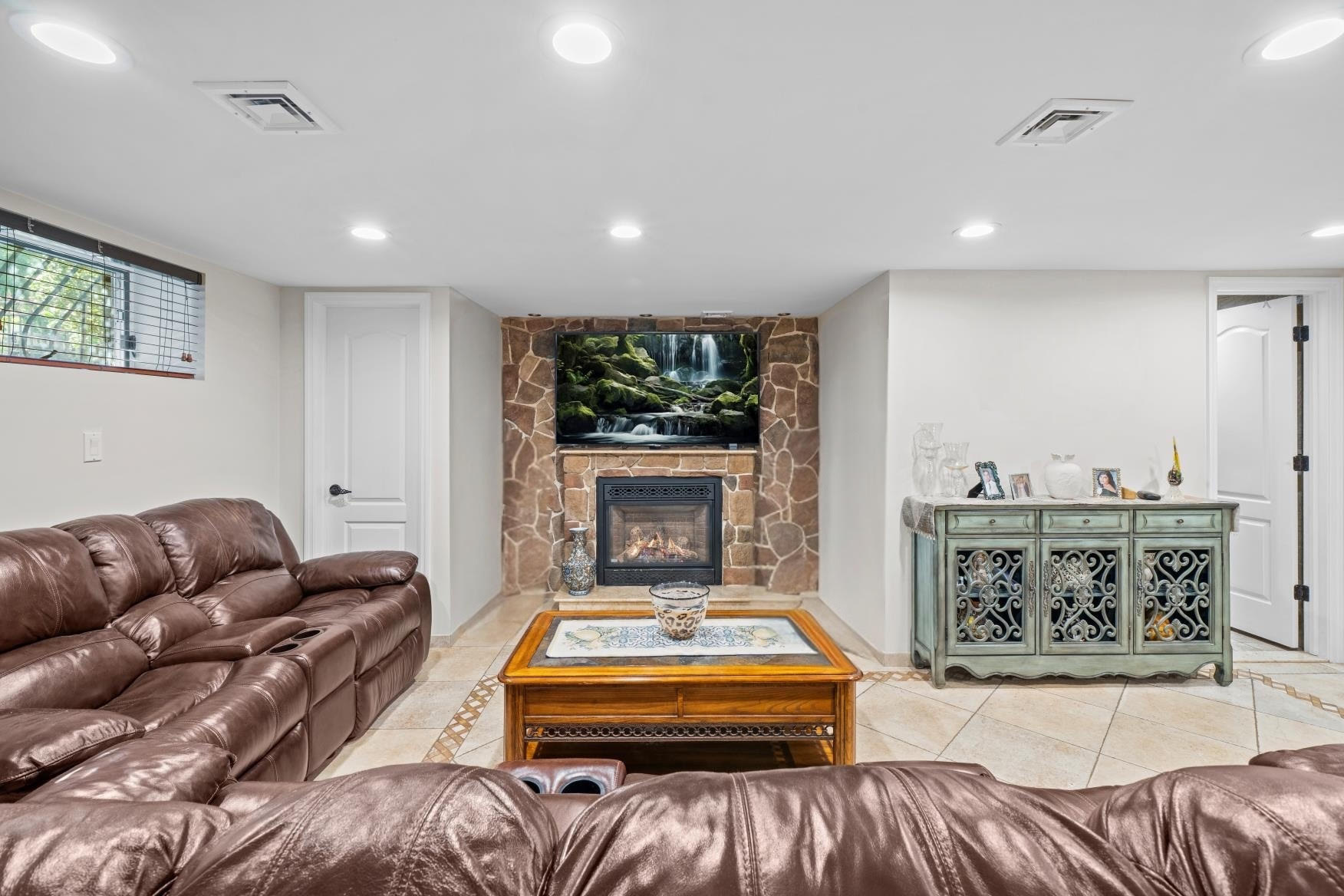 2253 East 64th Street Brooklyn, NY 11234 - Photo 28 of 45 a living room with furniture a rug and a fireplace