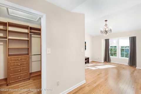 a view of a room with wooden floor and windows