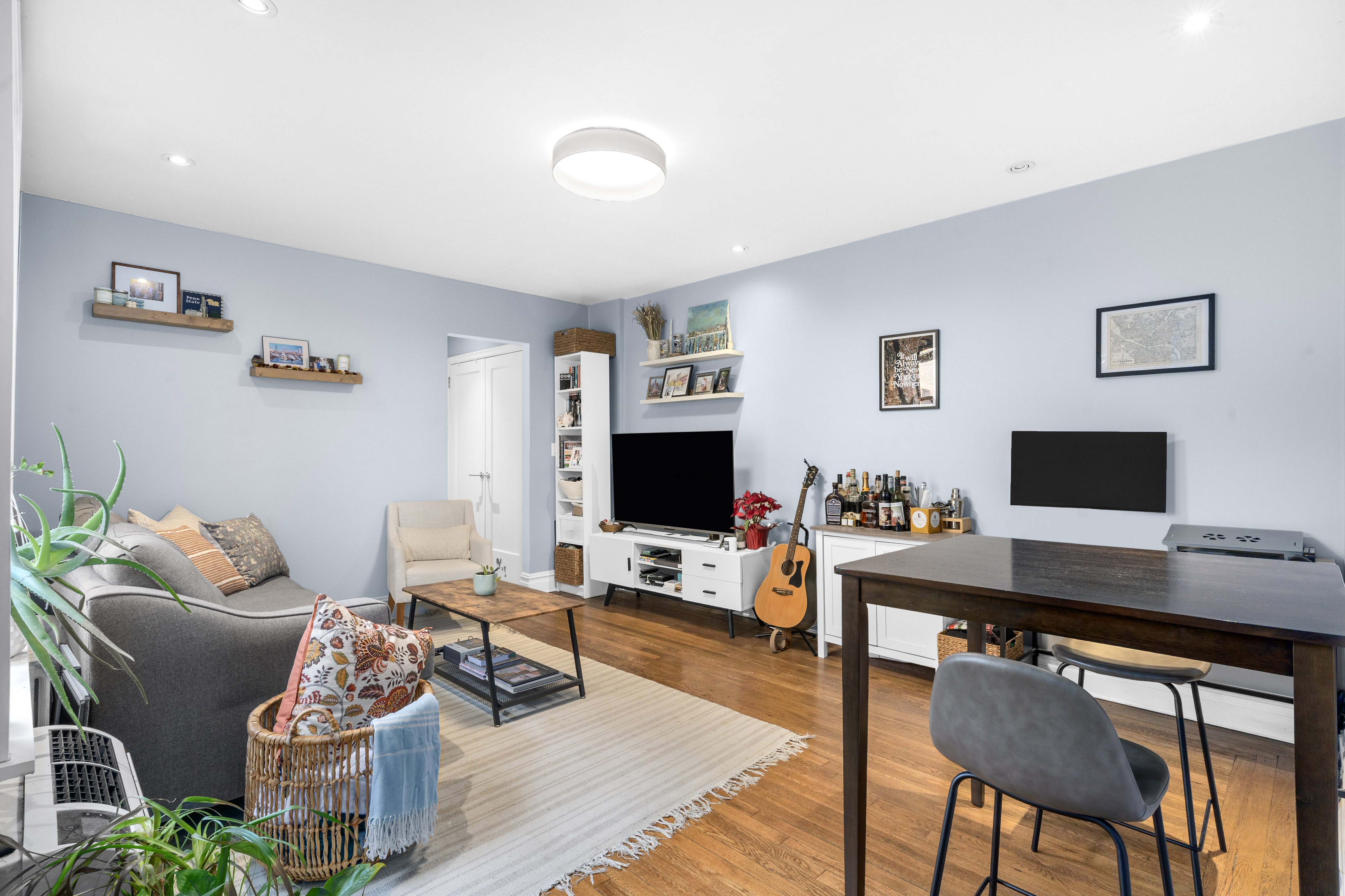 319 West 18th Street, Unit 4H Manhattan, NY 10011 - Photo 1 of 6 a living room with furniture and a flat screen tv