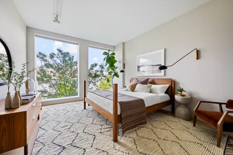 a bedroom with a bed and a couch