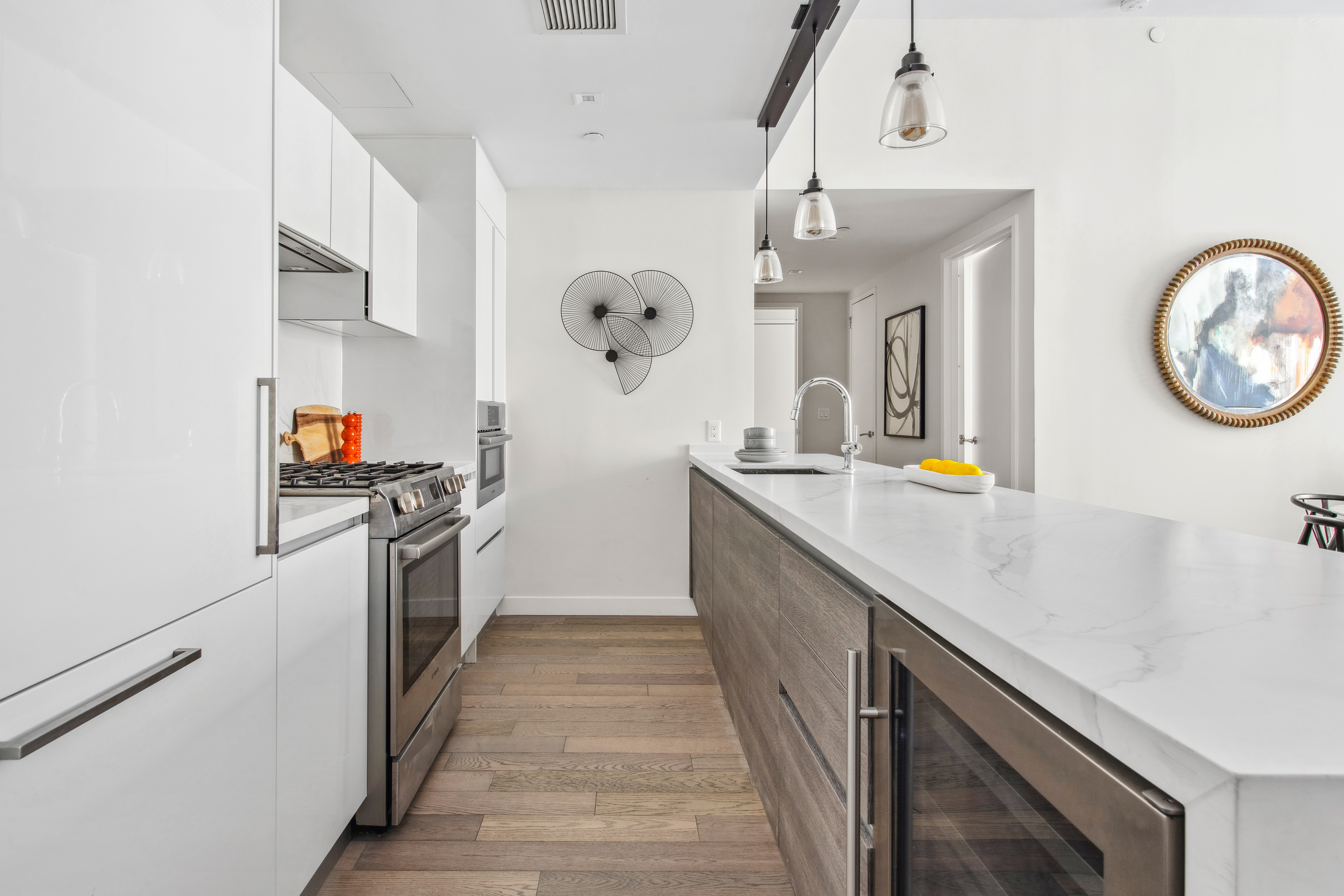 505-513 West 43rd Street, Unit 2B Manhattan, NY 10036 - Photo 4 of 18 a kitchen with a sink cabinets and appliances