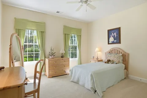 a bathroom with a granite countertop sink mirror vanity and toilet