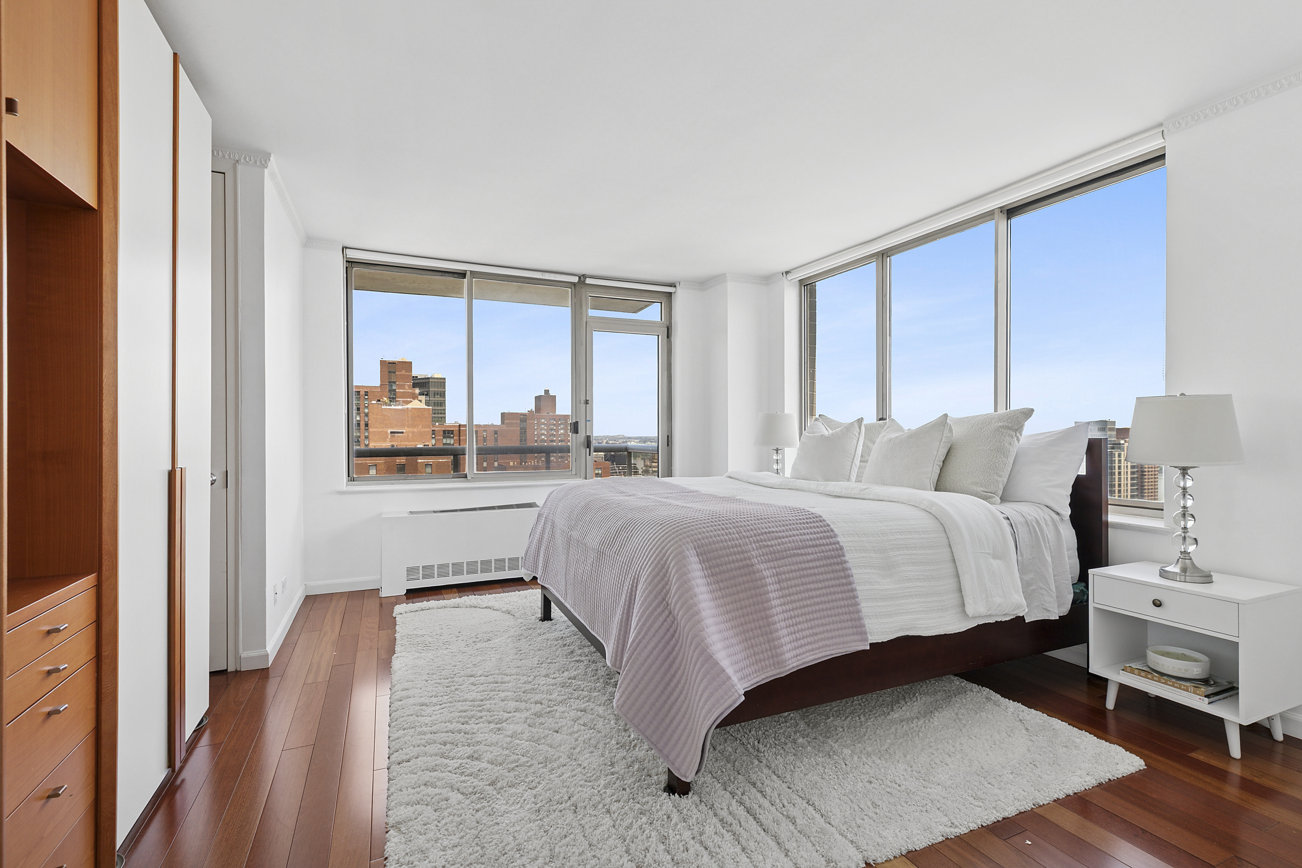 200 East 89th Street, Unit 34CD Manhattan, NY 10128 - Photo 7 of 20 a bedroom with a bed and a view of balcony