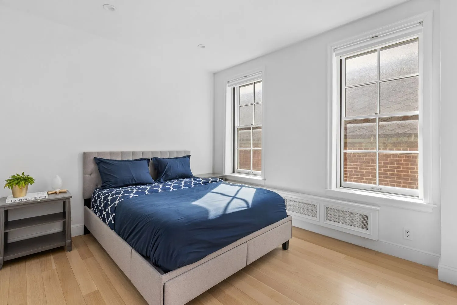 a large bed sitting in a bedroom next to a window