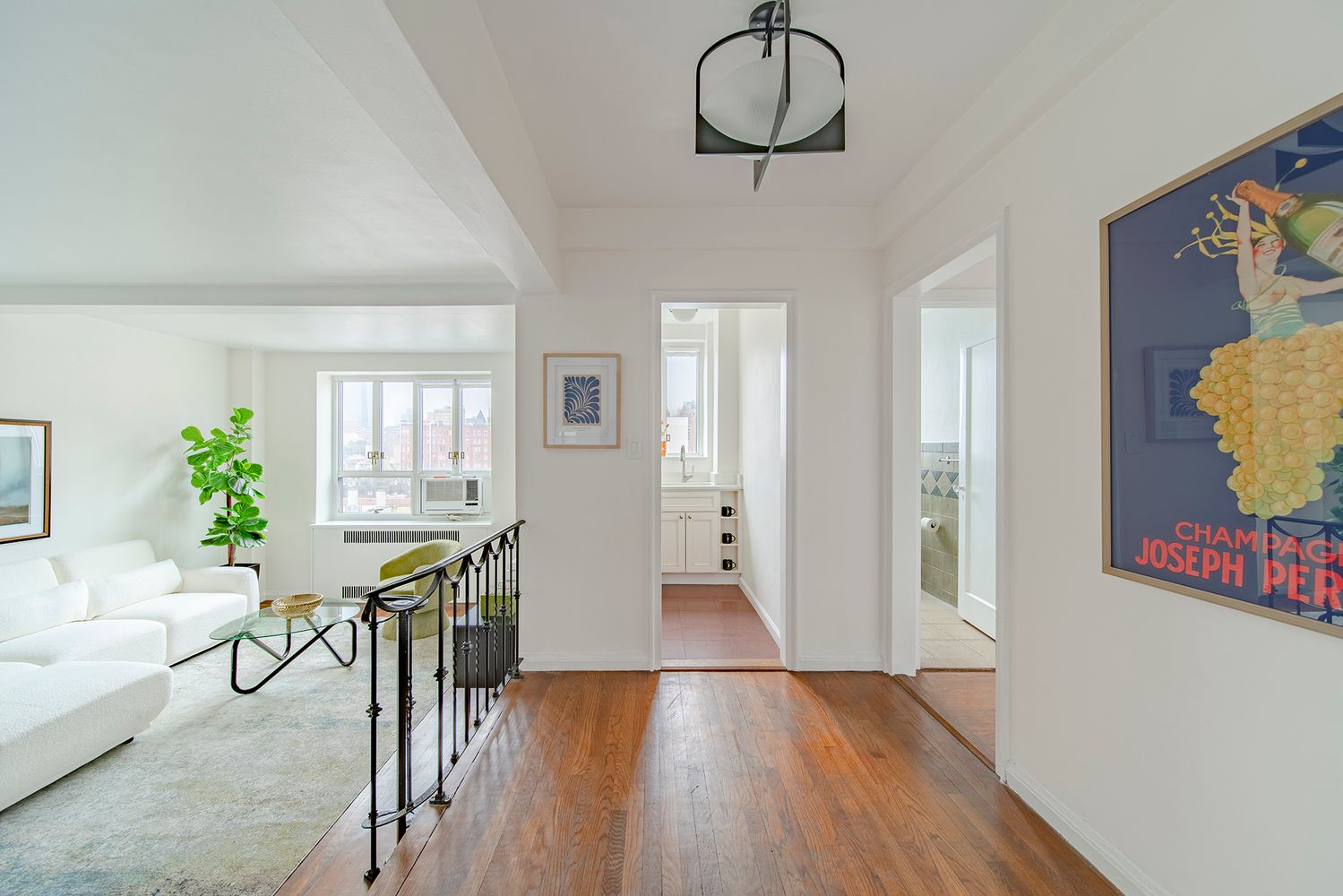 a view of a room with furniture wooden floor and windows