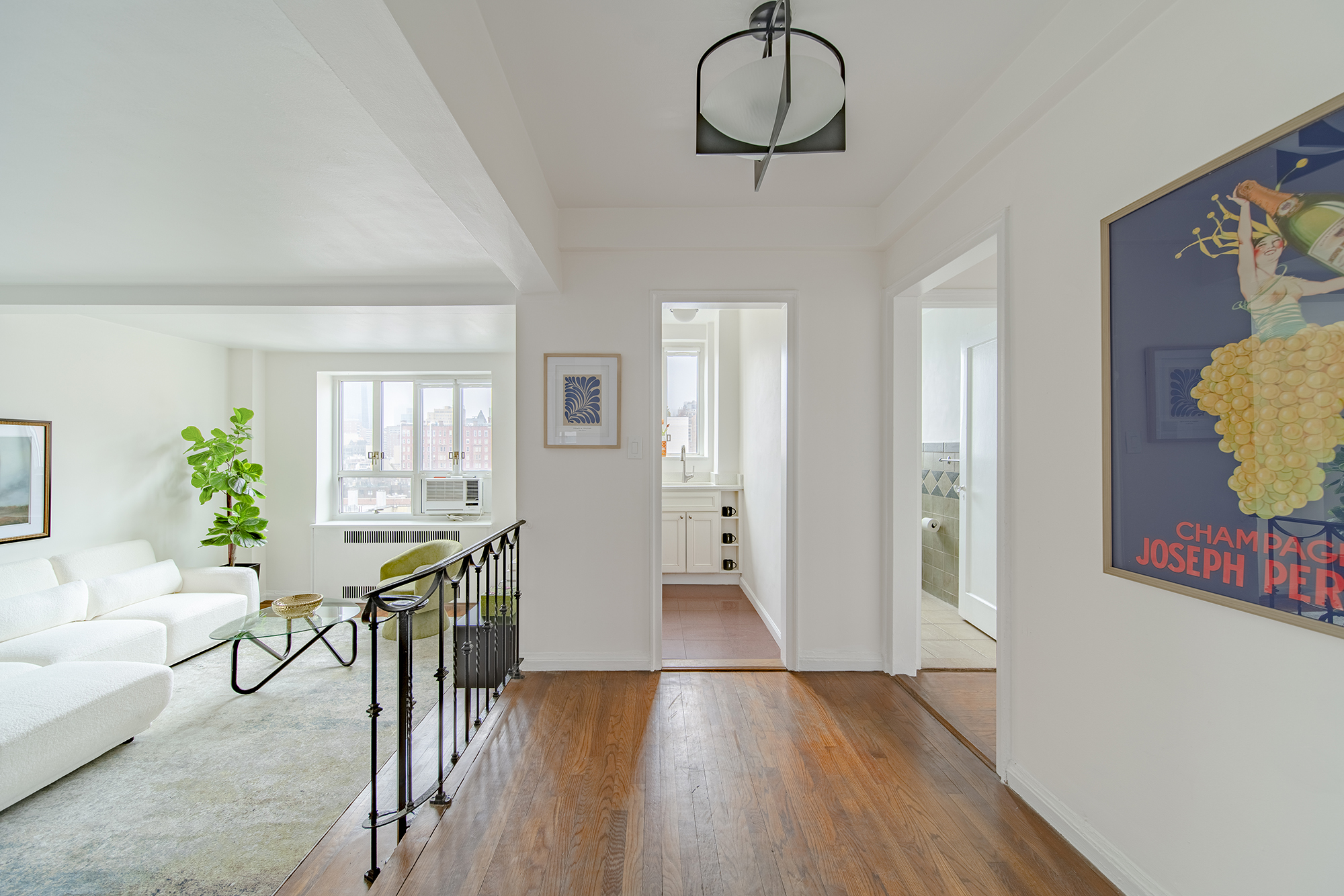 a view of a room with furniture wooden floor and windows