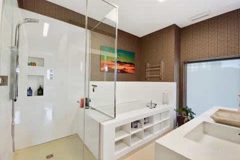 a bathroom with a tub sink and mirror