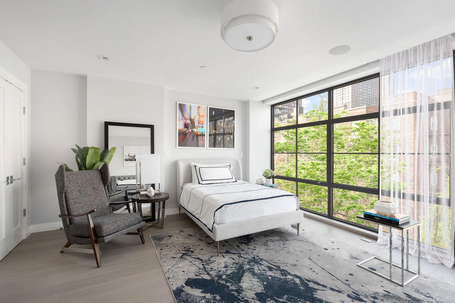 520 East 89th Street Manhattan, NY 10128 - Photo 27 of 40 a spacious bedroom with a bed and a large window