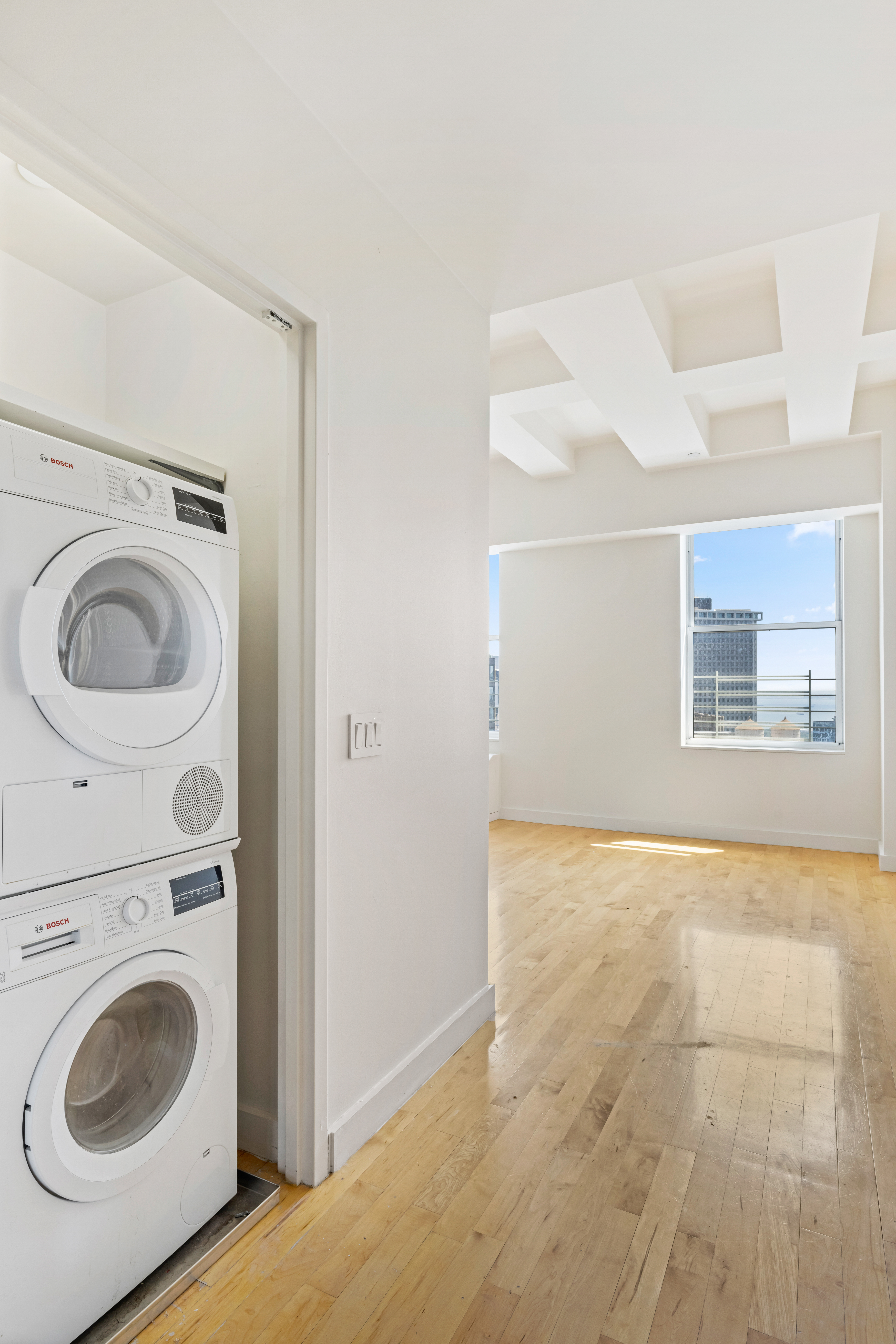 15 Broad Street, Unit 3930 Manhattan, NY 10005 - Photo 11 of 21 a view of a bedroom with washer and dryer