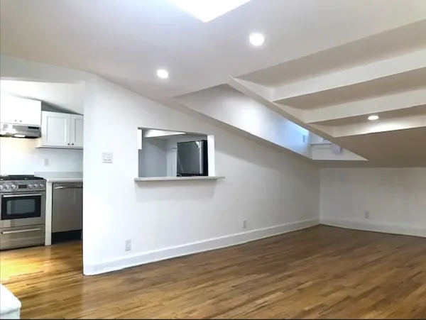 a view of a kitchen with a sink and a stove top oven