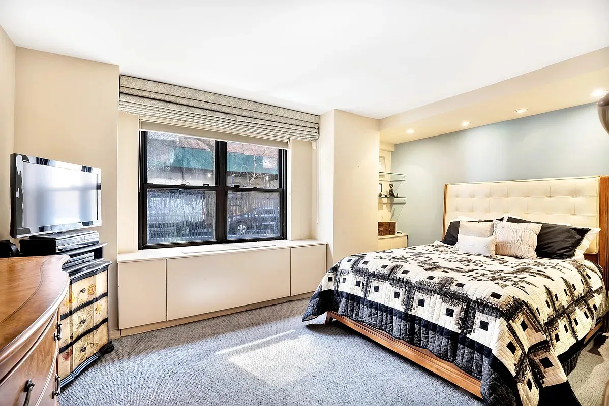 a bedroom with a bed and a window