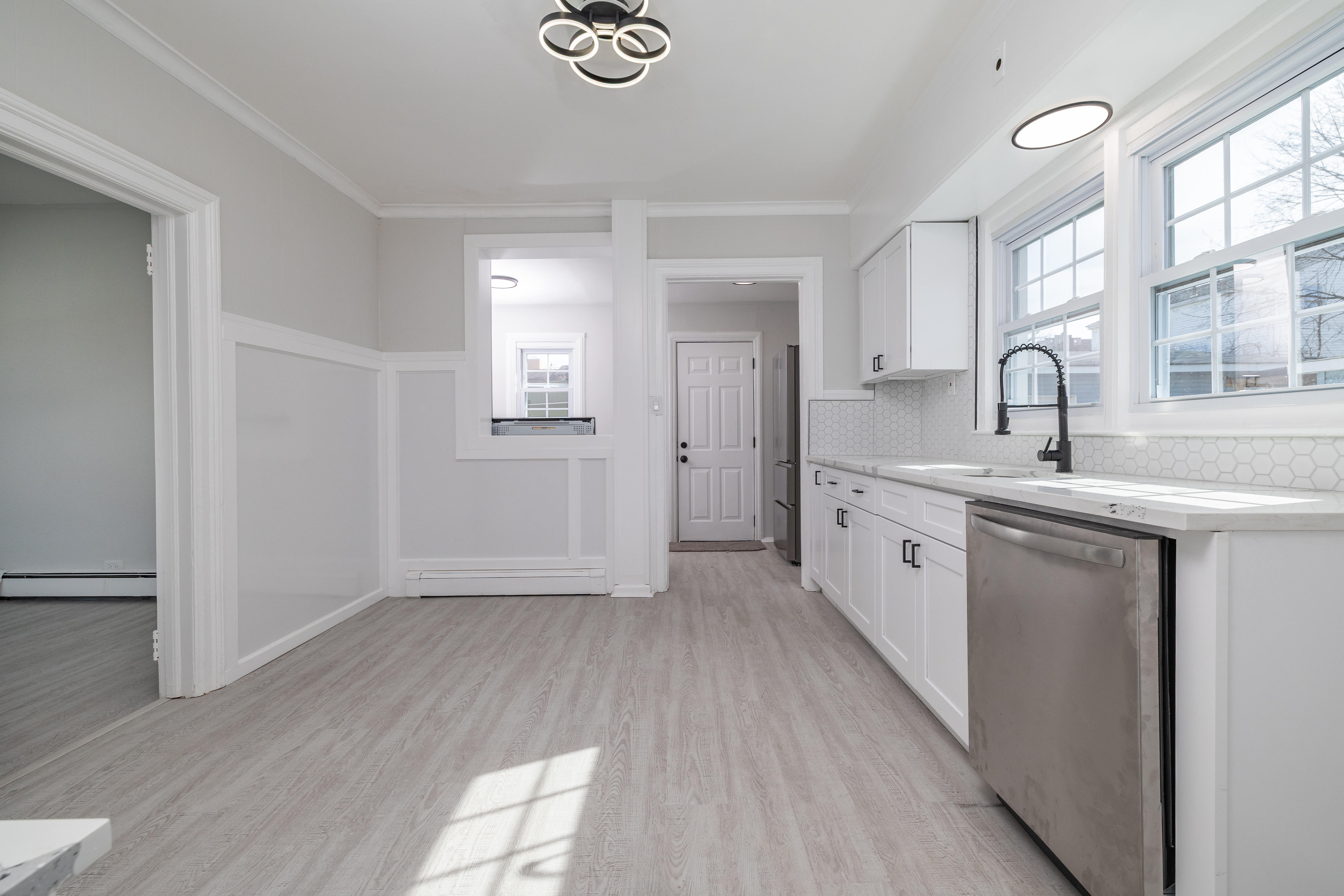 13-03 Brunswick Avenue Queens, NY 11691 - Photo 6 of 27 a view of a kitchen with sink dishwasher and wooden floor