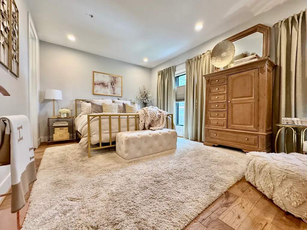 a spacious bedroom with a bed and furniture